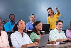 Technical School instructor teaching adult students how to program in Python.